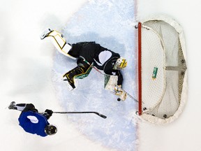 London Knights goalie Emanuel Vella fends off a shot during a team practice at Budweiser Gardens in London on Thursday. The Knights and Erie Otters clash Friday with the OHL regular season crown up for grabs. (CRAIG GLOVER, The London Free Press)