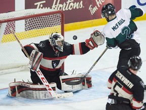 Kendall McFaull (right) of the University of Saskatchewan Huskies' is stopped by Carleton Ravens goalie Patrick Killeen during CIS championship hockey action in Halifax on Thursday, March 17, 2016. (Andrew Vaughan/THE CANADIAN PRESS)