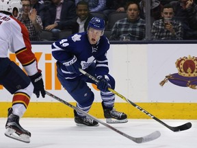 Leafs defenceman Morgan Rielly (right) looks up while trying to get past Panthers defenceman Aaron Ekblad (left) during second period NHL action in Toronto on Thursday, March 17, 2016. (Peter Power/THE CANADIAN PRESS)