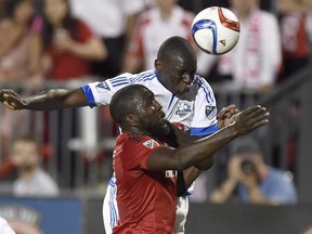 Toronto FC’s Jozy Altidore (bottom) and Impact’s Bakary Soumare battle for a header last season. Altidore has been out with a hamstring injury, but should be good to go on Sunday. (CP)
