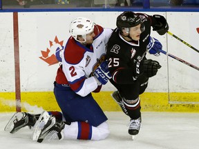 Oil Kings Kyle Yewchuk  checks Red Deer Rebels Adam Musil during Thursday's game iat Rexall Place. (Larry Wong)