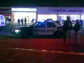 This still image taken from video provided by KPRC shows police responding to the scene of a shooting, Thursday, March 17, 2016 in Houston. Police fired at five suspected robbers Thursday night outside the furniture store, killing two and injuring two other members of the group, which was being monitored by a tactical team investigating other robberies earlier in the day. (KPRC via AP)