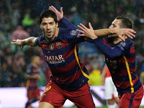 Barcelona's Luis Suarez celebrates after scoring his sideís second goal during the Champions League round of 16 second leg soccer match between FC Barcelona and Arsenal FC at the Camp Nou stadium in Barcelona, Spain, Wednesday, March 16, 2016. (AP Photo/Emilio Morenatti)
