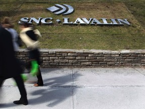 Pedestrians walk past a sign for the head office of SNC Lavalin in downtown Montreal March 26, 2012. (Reuters)