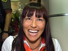 Chantal Petitclerc, winner of five gold medals at the 2008 Paralympics in Beijing, is shown showing her medals as she arrives at Trudeau airport in Montreal Friday, Sept. 19, 2008. Petitclerc has been named as a new senator. THE CANADIAN PRESS/Ryan Remiorz