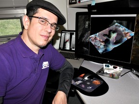Livio Tornabene, an adjunct research professor in Western’s Department of Earth Sciences and a core member of the Centre for Planetary Science and Exploration, in his London Ont. office March 15, 2016. The image on his computer is one of Tornabene’s simulated infrared-colour and 3D renderings of the Nili Fossae region on Mars at 4.6 meters per pixel. The Nili Fossae region is thought to be one of the potential source regions for transient methane gas in the Martian atmosphere that the ExoMars Trace Gas Orbiter is hoping to detect. CHRIS MONTANINI\LONDONER\POSTMEDIA NETWORK