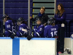 Woodstock's Kelly Paton, third from the right, talks to a player coming off the ice during a Western University Mustangs game. After a successful career as a player in women's hockey, she's in her first-year an associate coach for Western University's women's hockey team this season. Greg Colgan/Woodstock Sentinel-Review/Postmedia Network