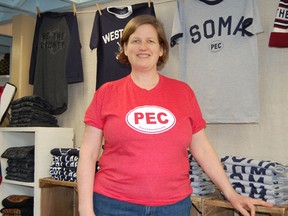 Submitted Photo
Lucinda Pritchard, owner of County T-Shirt Company, shows off one of their shirts at their store in Bloomfield. The company is running an inaugural T-shirt design contest with $5 from the sales of the winning design going to a County charity.