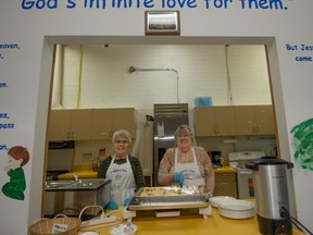 Volunteers Helen Steinberg and Kennair Winnie serve up shepherd’s pie at Auggie’s Cafe in the St. Augustine’s Parkland Anglican Church in Spruce Grove on Tuesday, March 15. Auggie’s Cafe serves a free meal to all residents every Tuesday, and is celebrating their five-year anniversary - Yasmin Mayne.