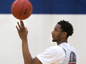 Marcus Capers balances a ball on his fingertip during a London Lightning practice at the Central Y on Friday.  (DEREK RUTTAN, The London Free Press)