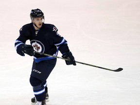 Mar 18, 2016; Winnipeg, Manitoba, CAN; Winnipeg Jets forward Nic Petan (19) watches the play during the second period against the Chicago Blackhawks at MTS Centre. Mandatory Credit: Bruce Fedyck-USA TODAY Sports