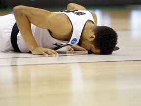Michigan State's Kenny Goins has trouble getting up after being injured during the first half in a first-round men's college basketball game against Middle Tennessee in the NCAA tournament on  Friday.. Middle Tennessee won 90-81. (AP Photo/Jeff Roberson)