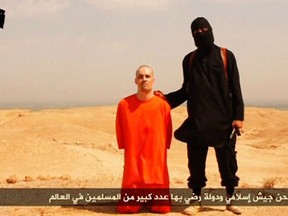 A masked Islamic State militant holding a knife speaks next to man purported to be U.S. journalist James Foley at an unknown location in this still image from an undated video posted on a social media website. Islamic State insurgents released the video on August 19, 2014 purportedly showing the beheading of Foley, who had gone missing in Syria nearly two years ago, and images of another U.S. journalist whose life they said depended on U.S. action in Iraq. The video, titled "A Message to America," was released a day after Islamic State, an al Qaeda offshoot that has overrun large parts of Iraq, threatened to attack Americans "in any place." U.S. officials said they were working to determine its authenticity. REUTERS/Social Media Website via REUTERS TV