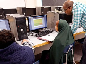 In this Jan. 8, 2016 photo, Somali-American teacher Abdinasser Ahmed runs a class for children in the program known as MENA, or Migrant Education Newcomer's Academy, at Fort Morgan Middle School, in Fort Morgan, a small town on the eastern plains of Colorado. The children, many of whom are part of the large local refugee population from Africa and Latin America, learn some of the basic linguistic and academic skills that are designed to help them integrate into life in this small farming community. (AP Photo/Brennan Linsley)