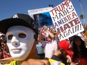 Protesters against Republican presidential candidate Donald Trump appear at a rally for Trump in Fountain Hills, Ariz, Saturday, March 19, 2016. (David Kadlubowski/The Arizona Republic via AP)