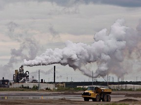 A dump truck works near the Syncrude oilsands extraction facility outside Fort McMurray, Alta., on June 1, 2014. (FILE pic) (THE CANADIAN PRESS/Jason Franson)