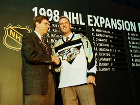 David Poile, general manager of the Nashville Predators, welcomes their first player, Mike Dunham in a special NHL expansion draft at the Marine Midland Arena in Buffalo on June 26, 1998. (Toronto Sun)