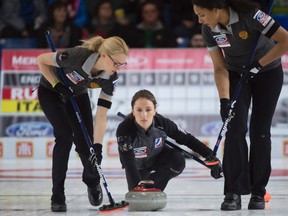 Russia skip Anna Sidorova, centre, makes a shot as second, Alexandra Raeva and lead, Nkeiruka Ezekh sweep during the first draw against Italy at the Ford World Women's curling in Swift Current, Sask., on Saturday, March 19, 2016. (THE CANADIAN PRESS/Jonathan Hayward)