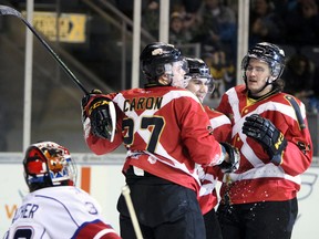 Kingston Frontenacs Cody Caron, Jared Steege and Conor McGlynn celebrate the Front's second goal of the game during the second period of Ontario Hockey League action at the Rogers KRock Centre in Kingston, Ont. on Saturday March 19, 2016. The Kingston Frontenacs defeated the Hamilton Bulldogs 5-2, concluding their regular season with a win. Steph Crosier/Kingston Whig-Standard/Postmedia Network