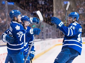 Maple Leafs' forward William Nylander (left) celebrates his goal with teammates Connor Brown and P.A. Parenteau during second-period action in Toronto on Saturday. (THE CANADIAN PRESS/PHOTO)
