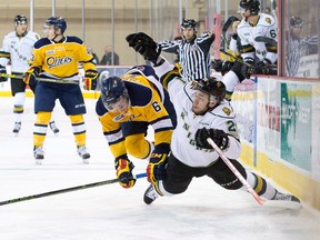 London Knights forward CJ Yakimowicz falls to the ice after being hit by Otters defenceman Jordan Sambrook during their OHL hockey game at Erie Insurance Arena in Erie, Pennsylvania on Saturday March 19, 2016. Craig Glover/The London Free Press/Postmedia Network