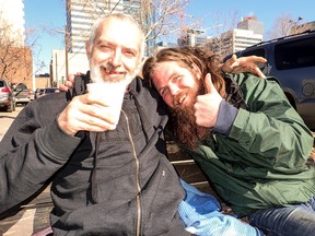 Stephen Gibson, left, and Shawn Gale sit on a bench at 100 Avenue and 102 Street on Friday. Gale says he’d visit a supervised injection site if one was available in the city. (MAX MAUDIE)