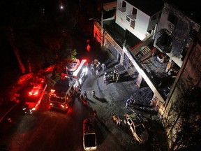Firemen work at the site where a single-engine plane crashed into a residence in the northern suburbs of Sao Paulo, Brazil, Saturday, March 19, 2016. According to Brazilian press reports, seven people died in the crash. Among those killed was Roger Agnelli the former CEO of Vale SA. (AP Photo/Nelson Antoine)