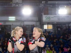 Team Canada third Amy Nixon, second Jocelyn Peterman and lead Laine Peters share a laugh during the third draw against Switzerland at the women's world curling championships in Swift Current, Sask., on March 20, 2016. (THE CANADIAN PRESS/Jonathan Hayward)