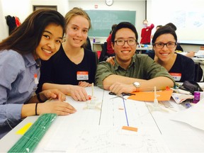 University of Ottawa engineering students, from left: Dawn Padiernos, Charlie Bates, Joseph Kim and Katie Chu show off their prototype of a ‘pop-up’ crosswalk, which they built Saturday as part of a design challenge organized by the campus chapter of Engineers Without Borders and Ottawa’s Healthy Transportation Coalition. MATTHEW PEARSON / POSTMEDIA