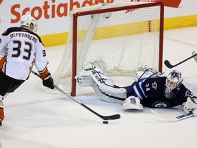 Anaheim Ducks’ Jakob Silfverberg (33) gets his own rebound and scores on Winnipeg Jets' goaltender Michael Hutchinson (34) during overtime to win the game during NHL hockey action in Winnipeg, Sunday, March 20, 2016. THE CANADIAN PRESS/Trevor Hagan