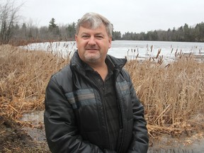 Bret Colman, standing along the shore of Loughborough Lake, north of Kingston, Ont. on Wednesday, March 16, 2016, is a member of the board of the Frontenac Stewardship Foundation, which is holding a presentation on preserving wetlands later this month. Michael Lea The Whig-Standard Postmedia Network