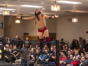 Shane Sabre cuts a saviour-like figure as he shows off to the crowd before his C*4 wretsling match Saturday against Viking. (Bruce Deachman, Ottawa Citizen)
