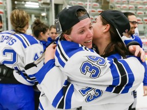 Marion Allemoz (L) cries while hugging teammate Alexandra Labelle as the Montreal Carabins celebrate winning the CIS Women's Hockey Championship at Winsport on Sunday.  (Lyle Aspinall)