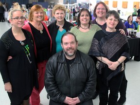 Members of Kingston Women in Action and the Kingston and District Civitan Club, from left, Jamie Bigras, Teri Wagar, Edie Emmons, Helena Fedora, Krista Ellis-Smith, and Robin O'Neill stand behind Jason Beaubiah, executive director of the Kingston Youth Shelter at the Kingston Women in Action Vendor's Event at the Collins Bay Legion on Saturday. (Steph Crosier/The Whig-Standard)