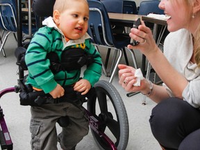Two-year-old Bo Patterson, listening to music with his mom Laura, gets some exercise in his specialized stroller. The Patterson family is thankful for the support they've received from Easter Seals Ontario to help purchase a bathing seat, which helps improve Bo's life. (Julia McKay/The Whig-Standard)