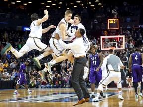 Notre Dame Fighting Irish guard Rex Pflueger (middle) celebrates with his teammates as time expires after tipping in the winning basket against the Stephen F. Austin Lumberjacks at Barclays Center in Brooklyn on March 20, 2016. (Anthony Gruppuso-USA TODAY Sports)