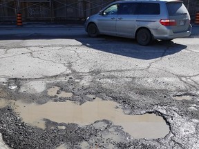 A pond-sized pothole is located at the intersection of Elm Street and Frood Road on March 11. (John Lappa/Sudbury Star)