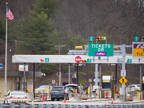 Police investigate at exit 180 off of the Pennsylvania Turnpike where a toll booth worker at the Fort Littleton Exchange was shot early Sunday, March 20, 2016 in an apparent robbery attempt. Authorities say a turnpike employee and another worker were shot and killed in the robbery attempt. The suspect in the shooting was also killed. (Daniel Zampogna/PennLive.com via AP)