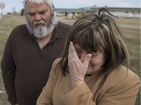 Carol-Ann Michaud, right, mother of Jean-Francois Michaud, and Dave Foulis, a close family friend, visit the site of her son's death on March 20, 2016 in the 200 block on Albuna Townline in Leamington, Ont. (Dax Melmer/Postmedia News)