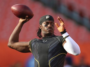 Former Washington Redskins quarterback Robert Griffin III warms up before the Redskins play the Cleveland Browns in an NFL preseason football game in Cleveland. (AP Photo/Ron Schwane, File)