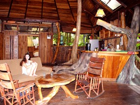 The main floor of Tree House Lodge in Costa Rica  features an open-air living room and kitchen with a live Sangrillo tree growing out of the floor and disappearing through the ceiling. STEVE MacNAULL/Special to Postmedia Network
