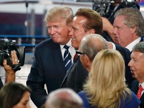 Republican presidential candidate and businessman Donald Trump, left, talks with actor and former California Gov. Arnold Schwarzenegger after the conclusion of the second official Republican presidential candidates debate of the 2016 U.S. presidential campaign at the Ronald Reagan Presidential Library in Simi Valley, Calif., on Sept. 16, 2015. (REUTERS/Lucy Nicholson)