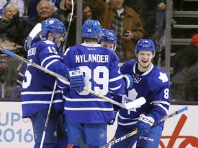 Toronto Maple Leafs defenseman Connor Carrick  gets congratulated by forward P.A. Parenteau and forward William Nylander after scoring the winning goal against the Buffalo Sabres at the Air Canada Centre. Toronto defeated Buffalo 4-1. (John E. Sokolowski/USA TODAY Sports)