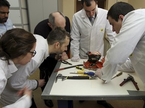 Aviation experts inspect the flight recorder from the crashed Boeing 737-800 Flight FZ981 operated by Dubai-based budget carrier Flydubai, in Moscow, Russia, in this handout image released by the Russia's Interstate Aviation Committee on March 20, 2016. REUTERS/Interstate Aviation Committee/Handout via Reuters
