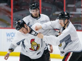 Senators veteran Chris Neil (left) instructs Nick Paul (centre) and Curtis Lazar on the finer points of protecting yourself during a fight at practice on Monday, March 21, 2016. (Errol McGihon/Ottawa Sun/Postmedia Network)