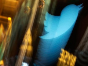 In this Wednesday Nov. 6, 2013, file photo, the Twitter logo appears on an updated phone post on the floor of the New York Stock Exchange.  (AP Photo/Richard Drew, File)