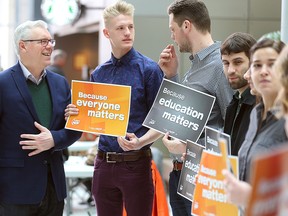 NDP leader Greg Selinger (left) speaks with students on Monday. (Brian Donogh/Winnipeg Sun)