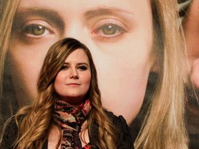 File photo of Austrian kidnap victim Natascha Kampusch posing in front of a film poster before the premiere of the film "3,096 Days" in Vienna on February 25, 2013. A new book reveals that kidnapper Wolfgang Priklopil filmed Kampusch doing chores, decorating and being forced to exercise while starving and naked. REUTERS/Herwig Prammer/FILES