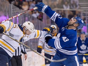 Toronto Maple Leafs centre Nazem Kadri gets his head knocked back during a collision with Buffalo Sabres defenceman Carlo Colaiacovo during second-period action at the Air Canada Centre in Toronto on March 7, 2016. (THE CANADIAN PRESS)