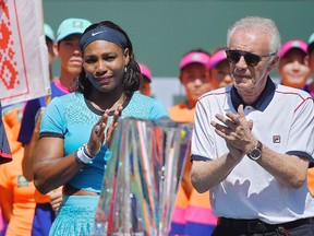 Serena Williams stands with tournament director Raymond Moore after Victoria Azarenka defeated Williams in the final at the BNP Paribas Open in Indian Wells, Calif., on Sunday, March 20, 2016. (Mark J. Terrill/AP Photo)